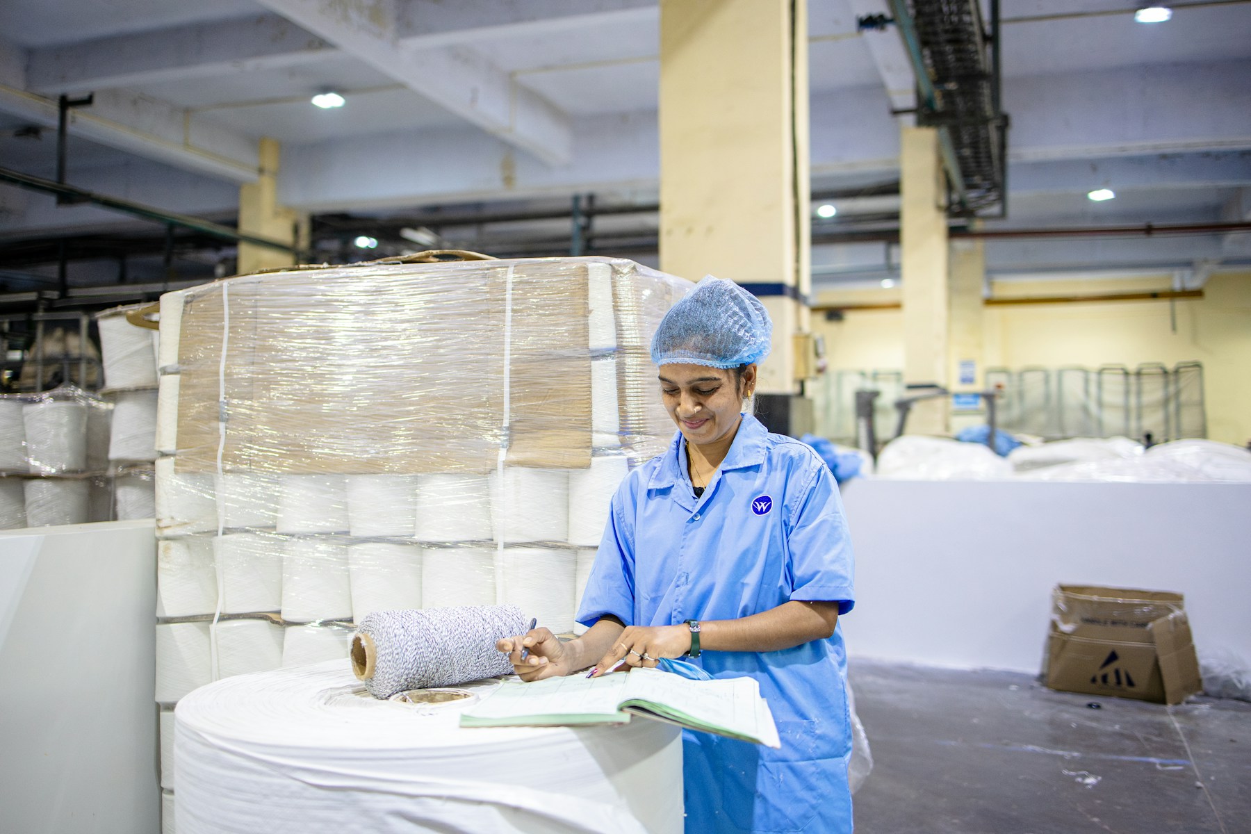 Textile worker inspecting materials for sports accessory quality control