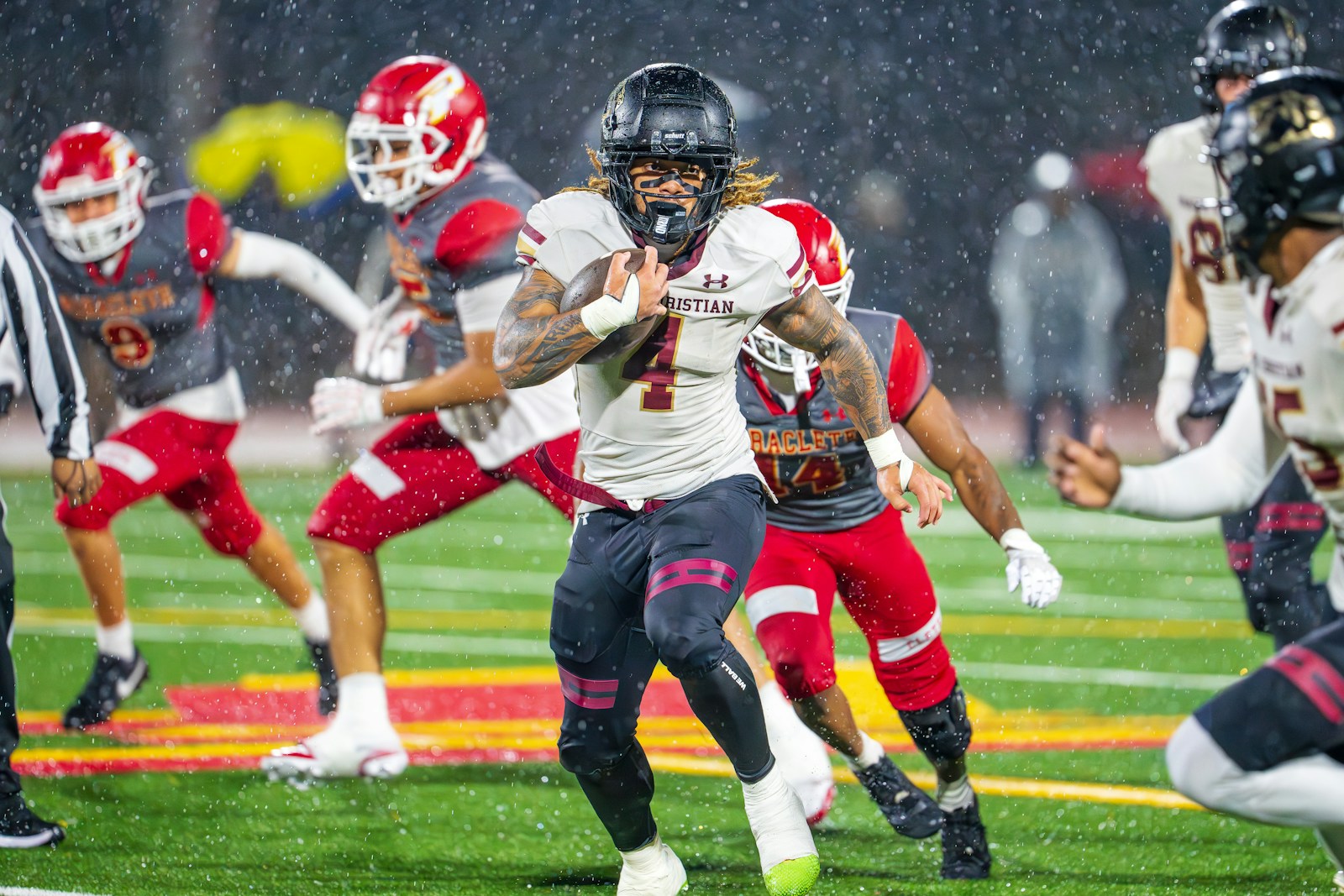 Football player running in rain representing all-weather durability